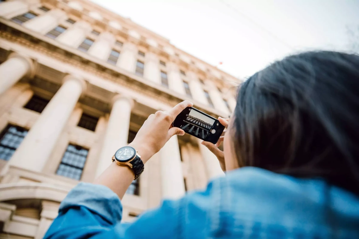Person taking photo of classic building